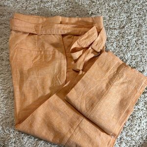 Light peach linen loop-belted slacks.